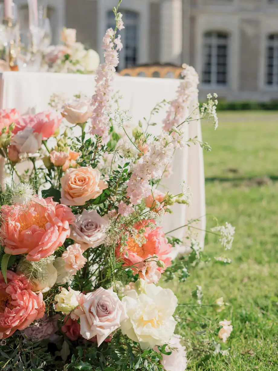 A bride and groom walking through a sunlit Mediterranean garden