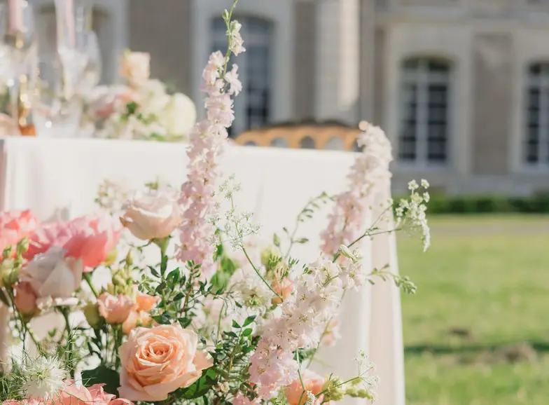 The bride and groom close together, framed in a wide band of soft daylight.