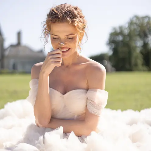 The bride in a doorway, her dress falling in long folds.