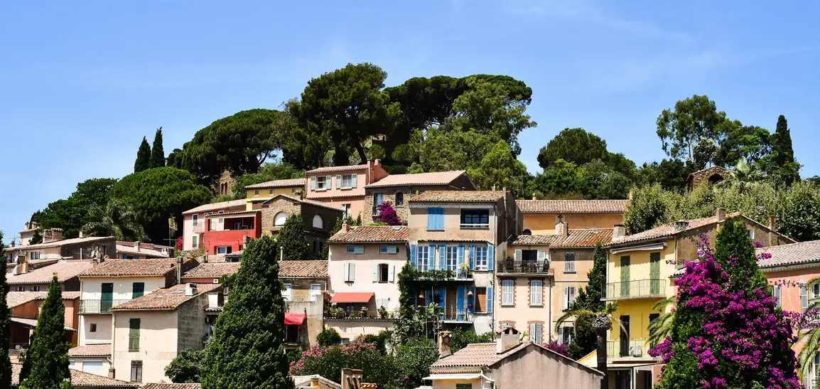 The old town of Grasse on its hillside, roofs and bell tower at dusk.